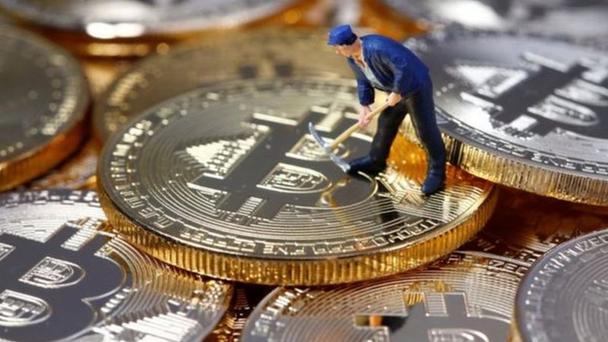 A close-up image of a cryptocurrency miner working on a mining machine, highlighting the technical expertise required in maintaining and optimizing mining operations.